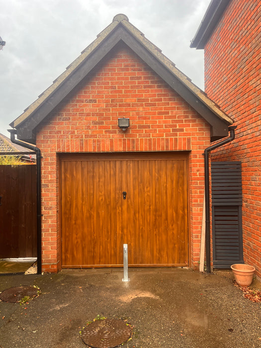 Bison Products Ramco 70 Driveway Security Post Installed for a small SUV and city car infant of garage.