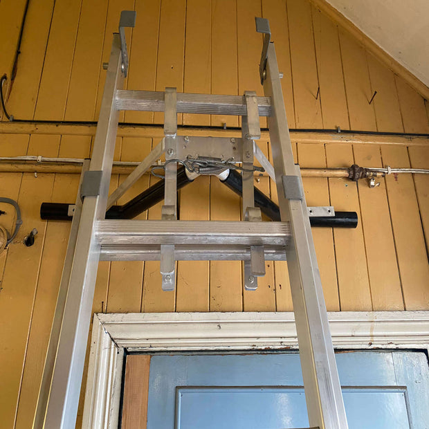 Industrial ladder Stand Off against wall indoors