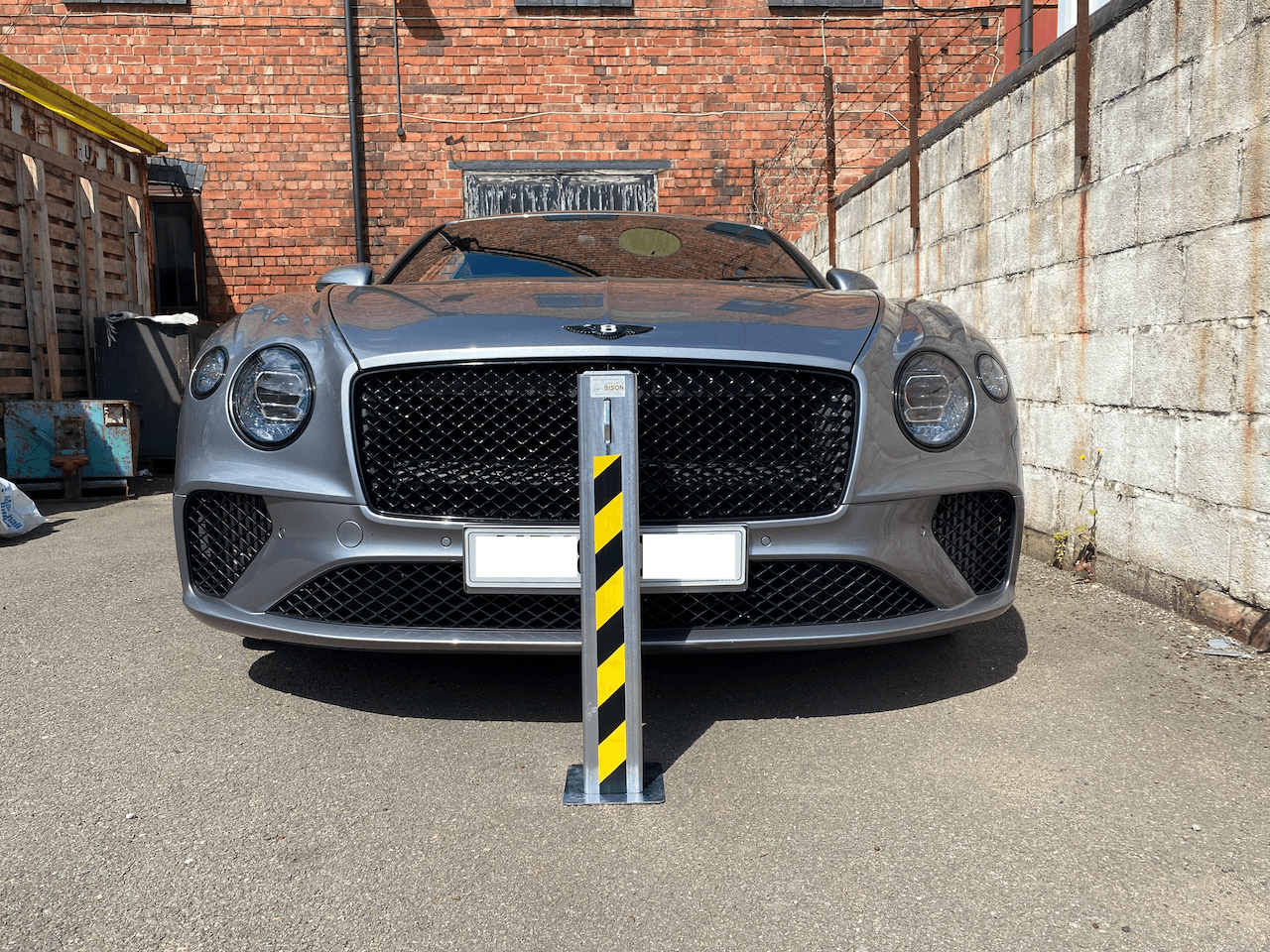 Ramco 70 telescopic security bollard infront of Bentley Continental