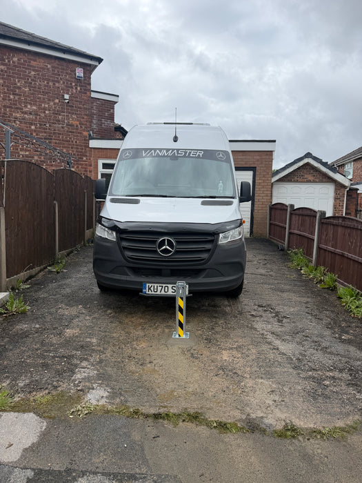 Ramco 100 telescopic security bollard with hi-vis tape installed on driveway protecting a Mercedes Sprinter Vanmaster campervan