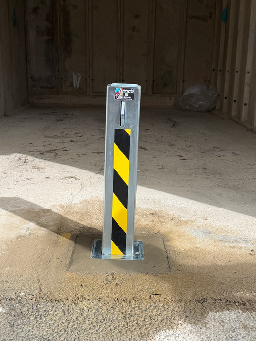 Ramco 100 galvanised telescopic security bollard with hi-vis yellow and black chevron tape installed inside a garage on concrete floor