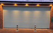 2 Ramco 100's installed infront of a garage with lights above.