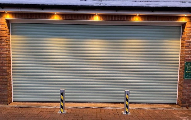 2 Ramco 100's installed infront of a garage with lights above.