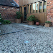 Ramco 100 driveway security bollard installed in gravel driveway at barn conversion lowered.