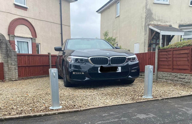 2 Ramco 100's installed on a gravel driveway infront of a BMW 5 series.