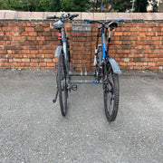 Adjustable bike rack for 3 bikes with tyre widths ranging from 15mm to 100mm 2 bikes stowed against a wall