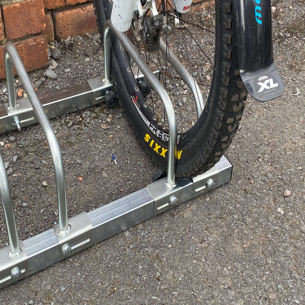 Adjustable bike rack for 3 bikes with tyre widths ranging from 15mm to 100mm showing fat tyre wheel