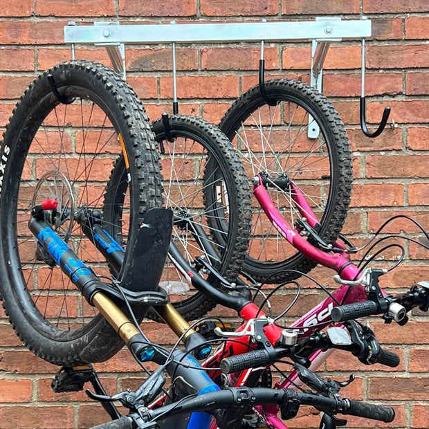 Vertical bike rack fixed to a brick wall