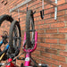 Vertical bike rack fixed to a brick wall