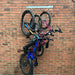 Vertical bike rack fixed to a brick wall