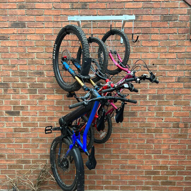 Vertical bike rack fixed to a brick wall