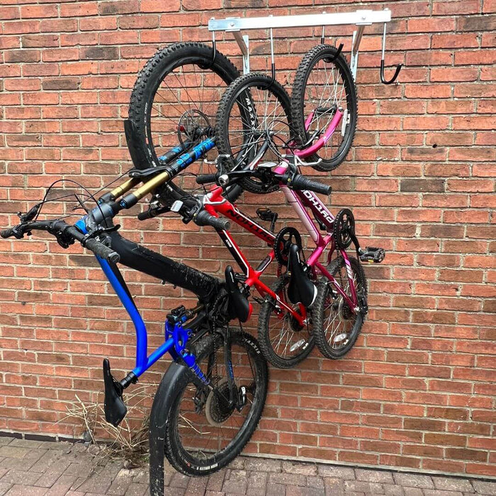 Vertical bike rack fixed to a brick wall