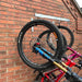 Vertical bike rack fixed to a brick wall